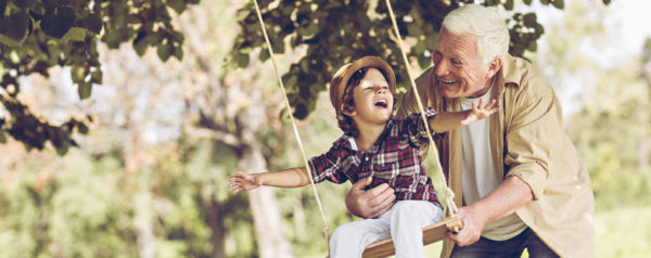 grandfather swinging his grandson