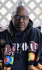Resident of the month Mr. W. D. wearing black hoodie and black rimmed glasses