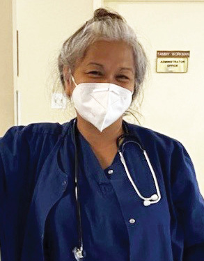 Healthcare Heroes Spotlight for the month of August is Emelda Cryder wearing dark blue scrubs and a medical mask