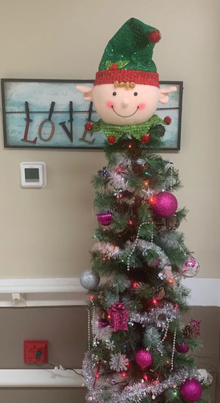 christmas tree with a large elf head sitting on top