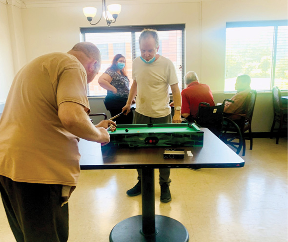 group of residents playing table pool