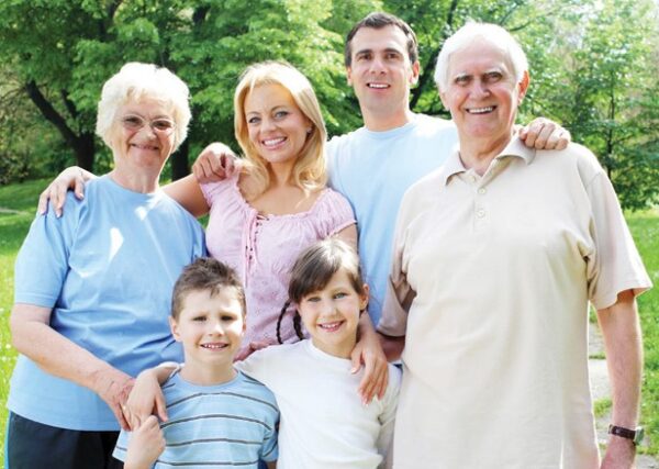multi-generational family in the park on sunny day, taking photo
